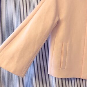 Mod style jacket with slight bell sleeve.